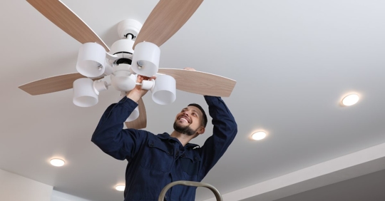 man working on ceiling fan