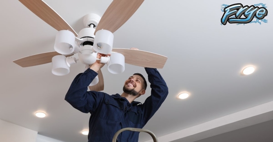 Woman with short white hair, white buttoned down shirt and blue cardigan sitting in black ergonomic office chair smiling at laptop screen.
